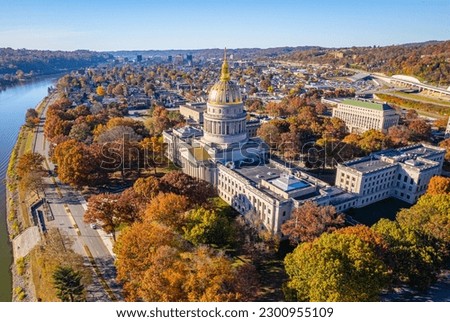 An aerial view of the West Virginia State Capitol Building and downtown Charleston with fall foliage