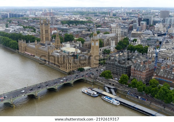 Aerial view of Westminster Palace,\
Westminster Abbey, Westminster Bridge and Thames River on a cloudy\
summer day. Photo taken August 3rd, 2022, London,\
England.