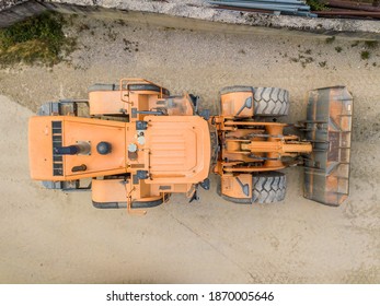 Aerial view of wheel loader in gravel pit for industrial mining.