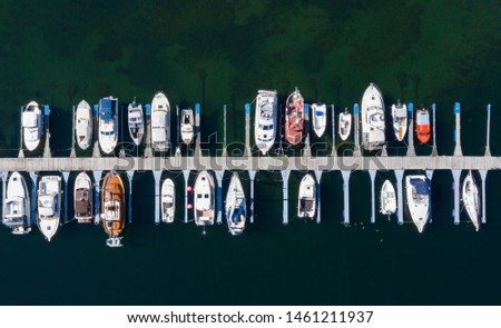 Aerial view of a lot of white boats and yachts moored in marina. Photo made by drone from above. Summer, Norway, Sognefjord, village Vik.