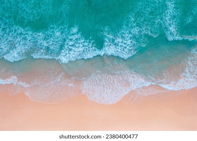 

aerial view White foam waves in the green sea lapping on the white sandy beach.
Wave after wave swept towards the shore.Freedom beach Patong Phuket Thailand. 
sea waves crashing on shore background
 - Powered by Shutterstock