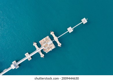 Aerial View Of White Oil Pipeline And Gas Pipeline Bridge Stretched Through The Sea