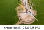 Aerial view of a wind turbine blade assembly on the ground in preparation for lifting up to the nacelle on the tower