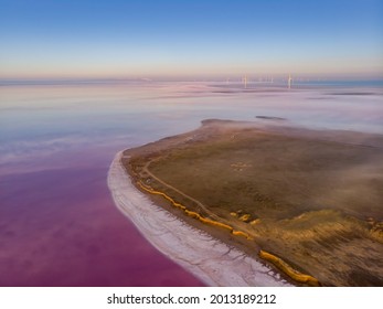 Aerial View Of A Wind Turbines At Lemurian Pink Salt Lake, Ukraine.