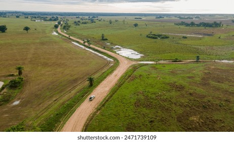 Aerial view of a winding dirt road through Casanare’s lush landscapes, Colombia - Powered by Shutterstock