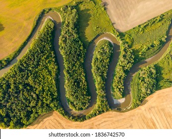 Aerial View of Winding River, Trees and Farm Fields on Summer Day in North Dakota.