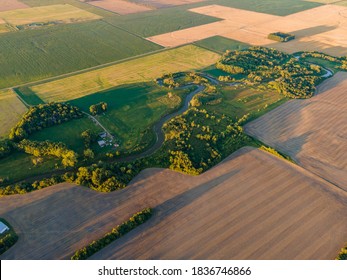 Aerial View Of Winding River, Trees And Farm Fields On Summer Day In North Dakota.