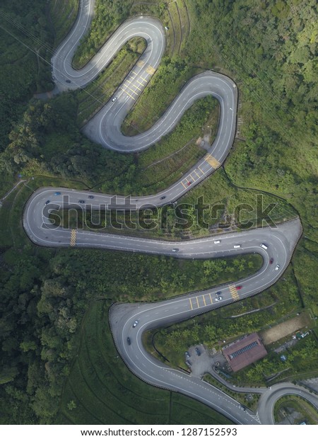 Aerial view of winding road from high mountain\
pass in Malaysia.