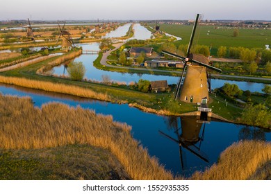 Aerial View Of Windmills In The Kinderdijk Area During Sunset. Spring In Holland