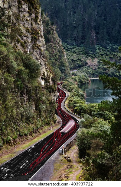 An aerial view of a windy road through a gorge in\
New Zealand. This is an information highway as a circuit board has\
been warped to fit the road and colorized in neon red in a vertical\
format.