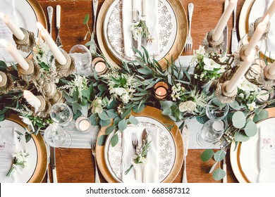 Aerial View Of Winter Green Garland On A Wedding Receptions Head Table With Gold Place Setting And Candelabra