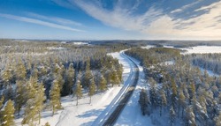 Aerial View Of Winter Road Cutting Through Scandinavian Forest In Sweden