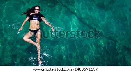 Aerial view of a woman relaxing in the sea 
