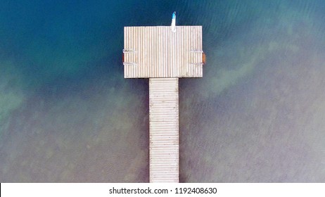 Aerial View Of Wooden Pier On Beautiful Sandy Beach.