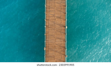 Aerial view of wooden pier in the sea.