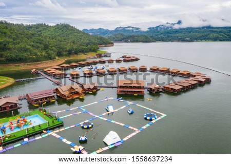 Aerial view, Wooden raft resort with waterpark in tropical forest on dam at Kanchanaburi, Thailand