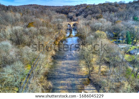 Aerial View of Woods in Fall Colors with a Road, Stream and Railroad Bridge