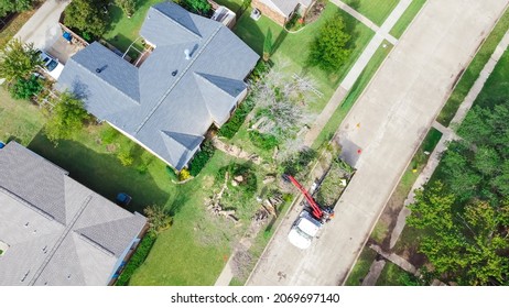 Aerial View Working Truck With A Lift Cutting Down Tree At Suburban House Near Dallas, Texas, America. Tree Pruning Landscaping Service At Residential Neighborhood.