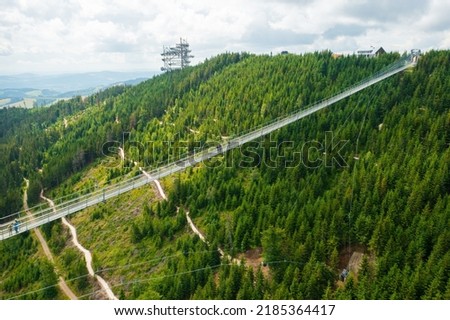 Aerial view of the worlds longest 721 meter suspension footbridge Sky bridge and observation tower the Sky walk in the forest, between mountains, Dolni Morava Ski Resort, Czech Republic. 