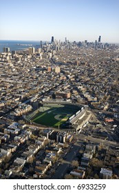 Aerial view of Wrigley Field with Chicago, Illinois skyline in background.