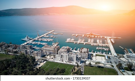 Aerial view of yacht marina on a background of mountains and the city of Porto Montenegro in Tivat