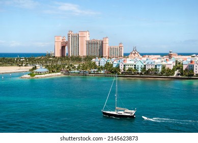 The aerial view of a yacht passing by in Nassau Harbour and Paradise Island skyline in a background (Bahamas).