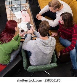 Aerial View Of Young Adult Friends Relaxing At The Living Room During Break Time.