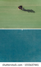 Aerial View Of Young Male Tennis Player Standing On Hard Court. Professional Tennis Player On Hardcourt.