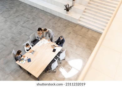 Aerial view at young startup team working in the modern office - Powered by Shutterstock