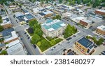 Aerial wide shot of Auburn Indiana city with focus on downtown courthouse