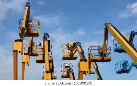 Aerial Work  Platform Of Cherry Pickers On Blue Cloudy Sky  Background