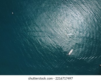 Aerial yacht on calm sea. Luxury cruise trip. View from above of white boat on deep blue water. Aerial view of rich yacht sailing sea. Summer journey on luxury ship. - Shutterstock ID 2216717497