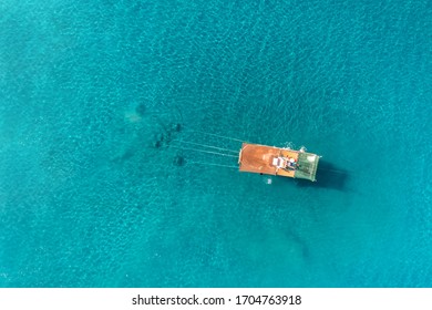 Aerial zenith view of a Shrimp boat in the Mediterranean, in front of the coast of Malaga. Picking the typical "concha fina" Malaga’s clam (Cytherea chione).