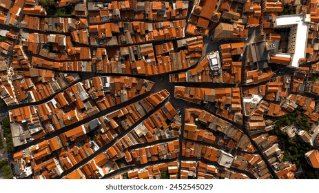 Aerial zenith view of the streets and alleys of the historic center of Iglesias, Italy. All houses have traditional red roofs. - Powered by Shutterstock