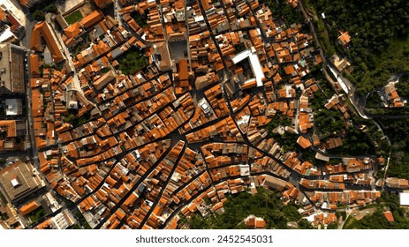 Aerial zenith view of the streets and alleys of the historic center of Iglesias, Italy. All houses have traditional red roofs. - Powered by Shutterstock