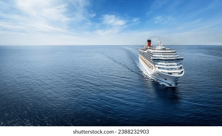 Aerialview of a generic cruise ship traveling with speed over calm ocean with copy space