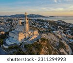 Aero Photography. View from flying drone. Old city center and aaport of Marseille (Vieux-Port de Marseille) and Basilique Notre-Dame de la Garde. at sunset. Top View. Beautiful destinations.