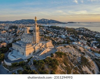 Aero Photography. View from flying drone. Old city center and aaport of Marseille (Vieux-Port de Marseille) and Basilique Notre-Dame de la Garde. at sunset. Top View. Beautiful destinations.