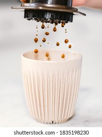 Aero Press Coffee Dripping Into Reusable Cup