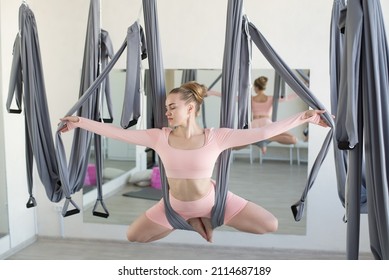 aero yoga training on suspended cloths in the form of a hammock is stretching and strengthening muscles, ligaments and joints, elements of yoga, pilates, gymnastics and aerial acrobatics