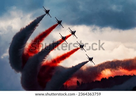 Aerobatic team at airshow. Flight demonstration and formation flying. Air force and military show. Airport and air base. Aviation and aircraft. Fly and flying. Commercial theme.