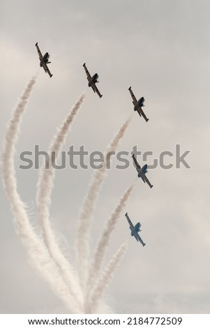 Aerobatics of five aircraft at an air show