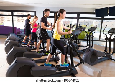 Aerobics elliptical walker trainer group at fitness gym workout - Powered by Shutterstock