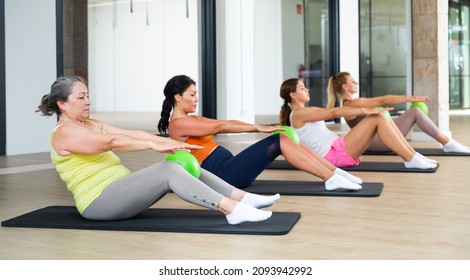 Aerobics pilates women with toning balls in a row on fitness class - Powered by Shutterstock