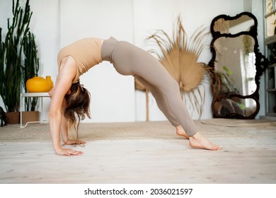 Aerobics trainer warming up joints and muscles. A confident female instructor is engaged in yoga in the asana pose. Harmony in the soul and body. Sports fortitude, exercises for health. - Shutterstock ID 2036021597