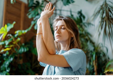 Aerobics is a warm-up of joints and muscles. A confident female instructor is engaged in yoga in the asana pose. The harmony of Zen in the soul and body. Strong fortitude, exercises for health. - Shutterstock ID 2036024273