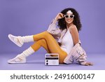 Aerobics. Woman with radio receiver on purple background