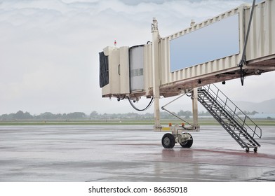 Aerobridge In Plane Parked With Rainy