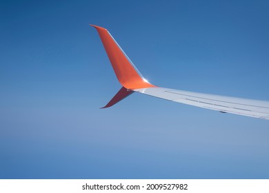 Aerodynamic Orange Wingtip In Flight On A Blue Background