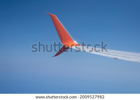 aerodynamic orange wingtip in flight on a blue background
